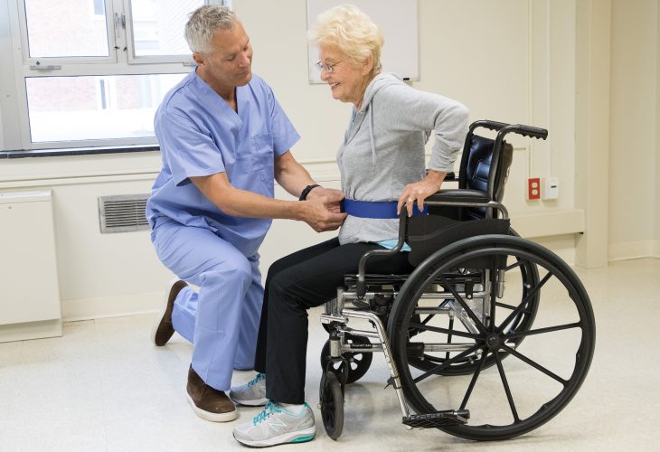 caregiver assisting wheelchair patient