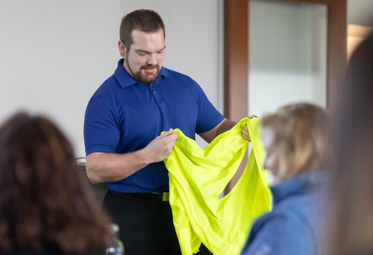 Safety trainer reviewing safety vest