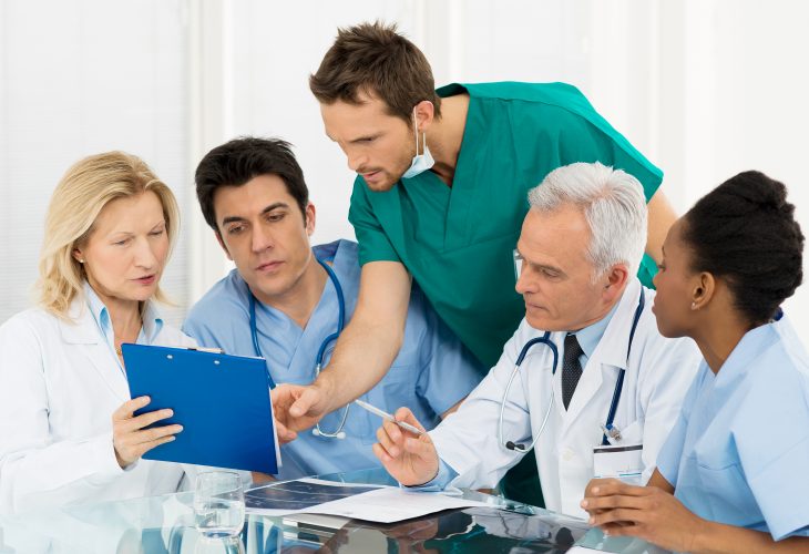 Team Of Doctors Examining Reports