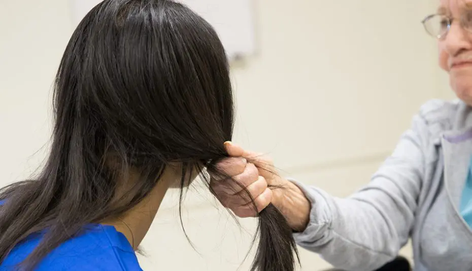 caregiver getting hair pulled by a patient