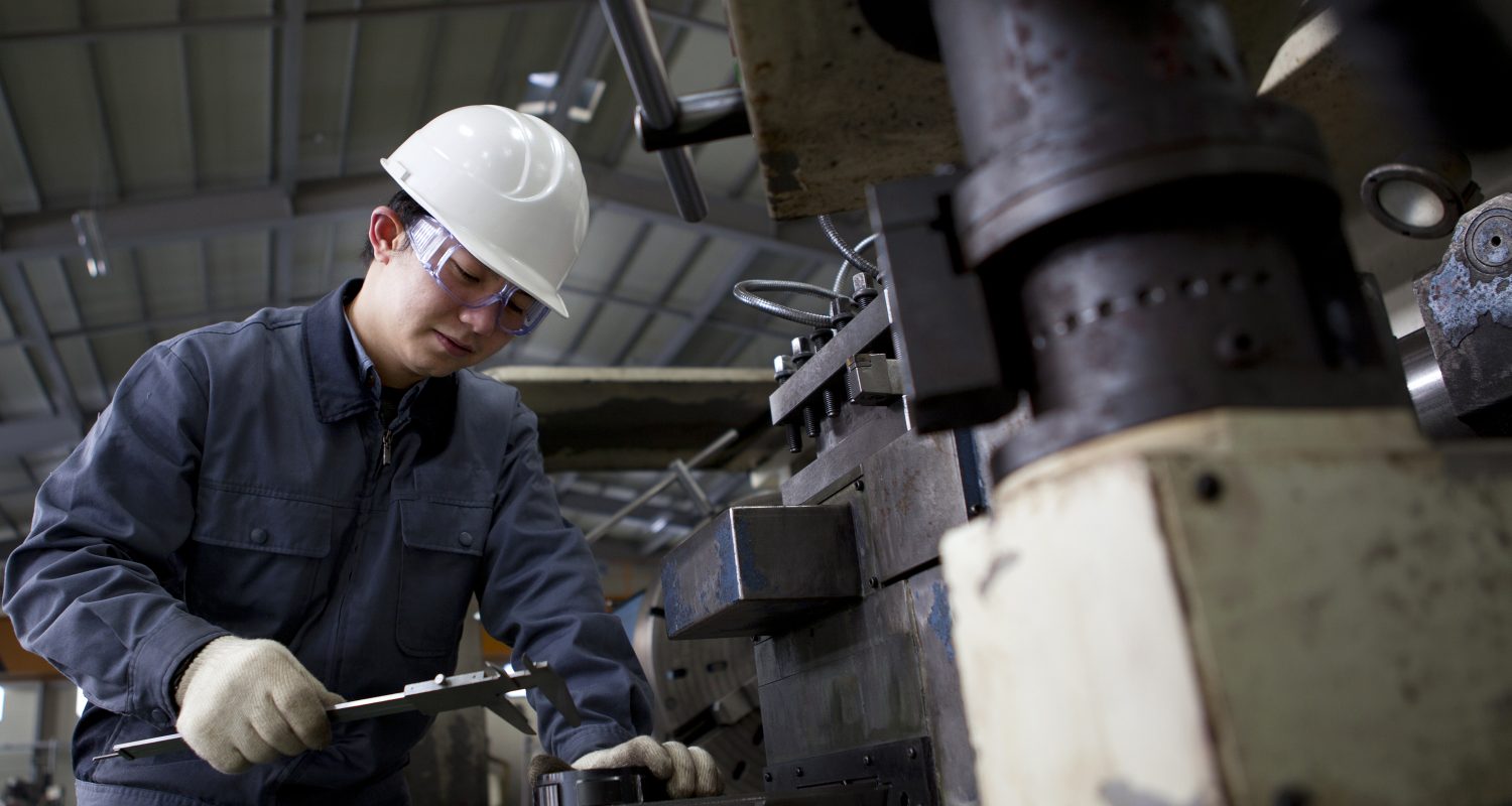 A mechanical technician measuring the detail