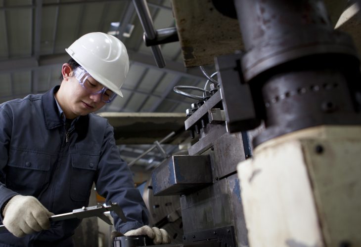 A mechanical technician measuring the detail