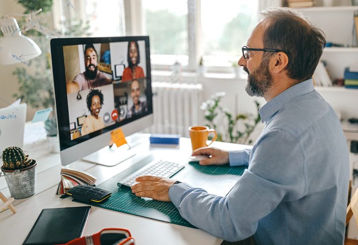 usinessman discussing work on video call with team members
