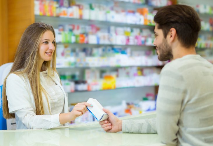 Pharmacist giving her client pills