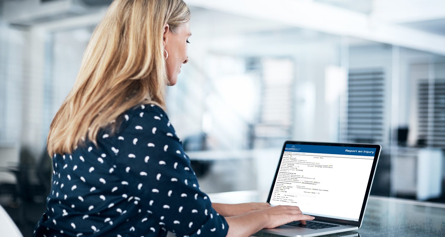 businesswoman using a laptop at her desk in a modern office
